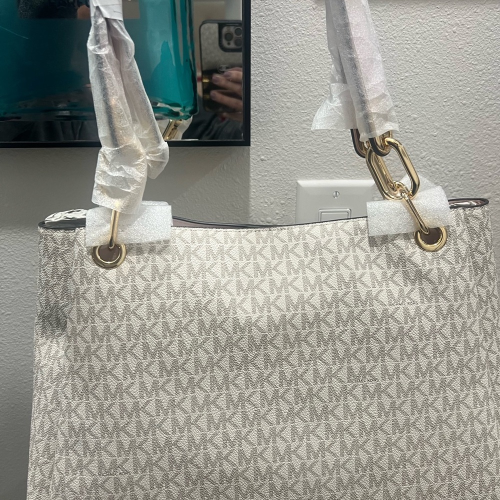 Michael Kors Jet set travel large Cream Signature Shoulder Bag with pink straps.